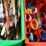 Art class supplies in colorful plastic bins
