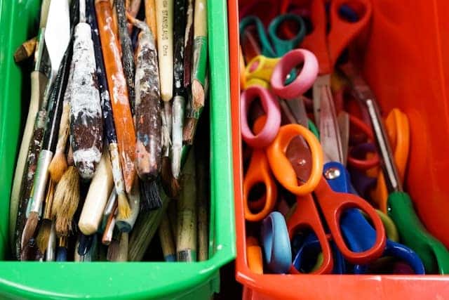 Art class supplies in colorful plastic bins
