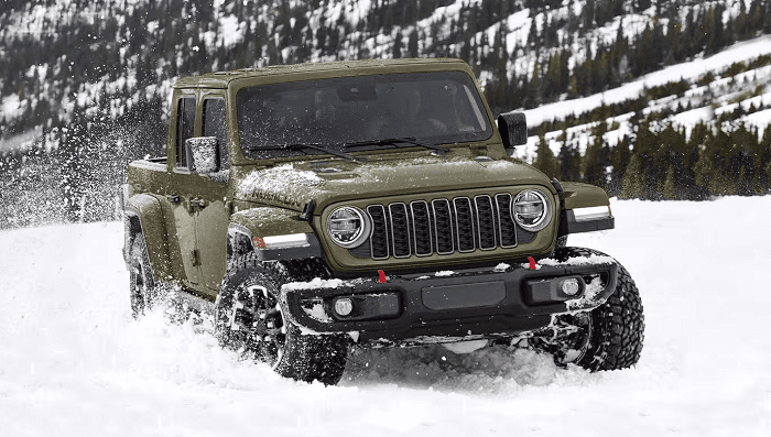 Green 2026 Jeep Gladiator Rubicon driving in the snow