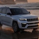 Gray 2026 Jeep Grand Cherokee driving on beach