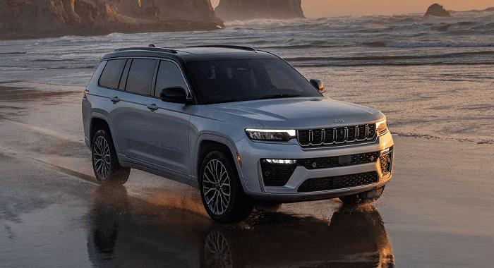 Gray 2026 Jeep Grand Cherokee driving on beach