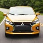Yellow 2024 Mitsubishi Mirage driving on the road