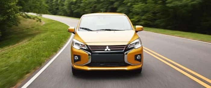 Yellow 2024 Mitsubishi Mirage driving on the road