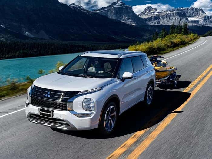 White Mitsubishi Outlander towing a jet ski