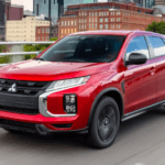 Red Mitsubishi Outlander Sport driving on road