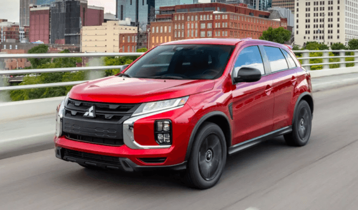 Red Mitsubishi Outlander Sport driving on road
