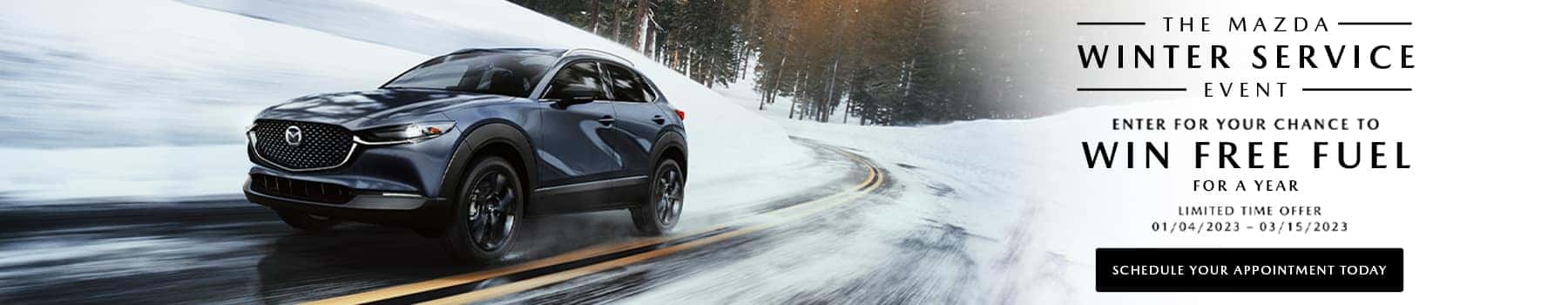 dark grey car driving on snowy road