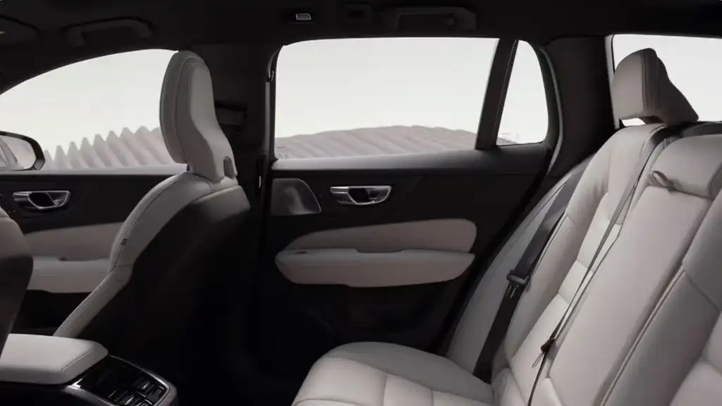 Rear passenger area of the 2026 Volvo V60 Cross Country showing supportive seating, door trim, and refined interior details.