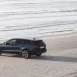 2026 Volvo V60 Cross Country parked on a sandy beach, highlighting AWD capability, elevated ride height, and rugged styling for Bristol, TN travel.