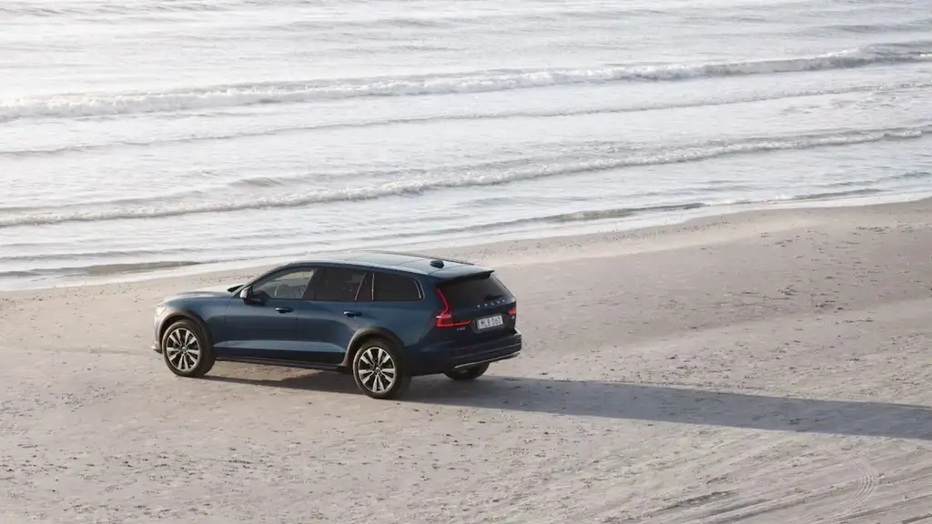2026 Volvo V60 Cross Country parked on a sandy beach, highlighting AWD capability, elevated ride height, and rugged styling for Bristol, TN travel.