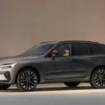 2026 Volvo XC60 Plug-In Hybrid parked indoors, showing a sleek gray SUV profile during a winter SUV comparison for drivers in Bristol, TN.