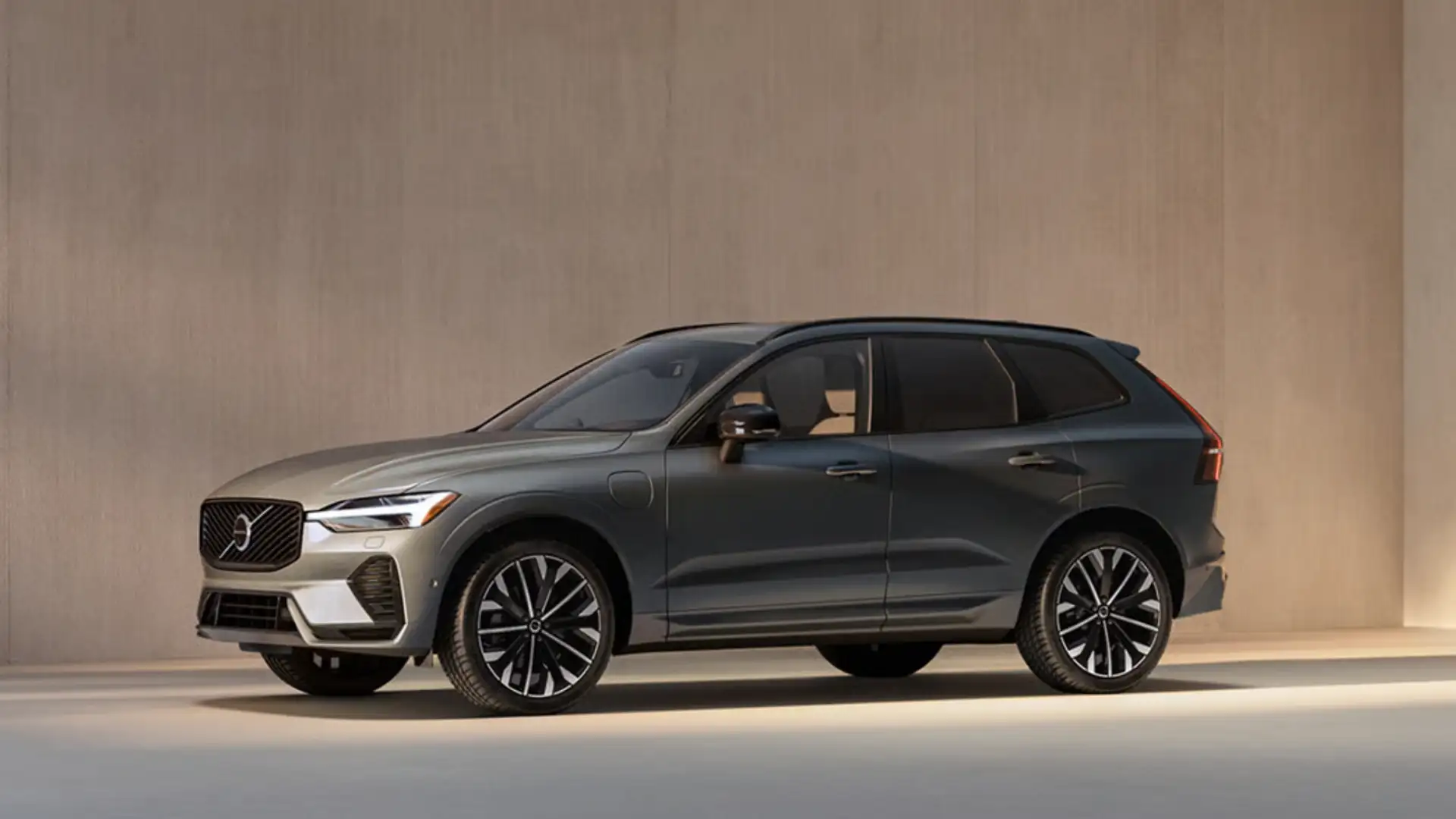 2026 Volvo XC60 Plug-In Hybrid parked indoors, showing a sleek gray SUV profile during a winter SUV comparison for drivers in Bristol, TN.