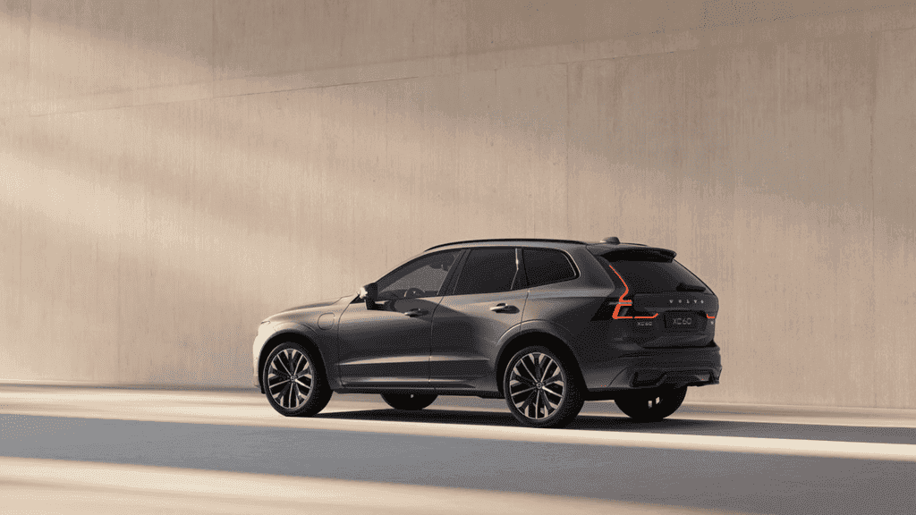 Side view of a 2026 Volvo XC60 Plug-In Hybrid parked against a modern wall, showcasing clean design and hybrid SUV styling near Kingsport, TN.