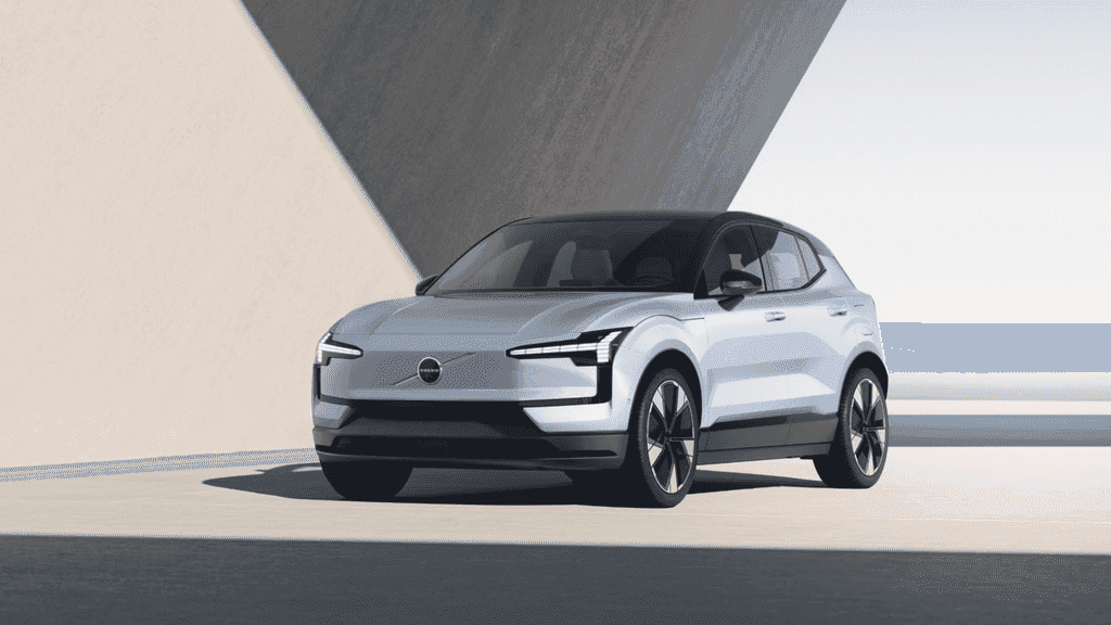 White 2026 Volvo EX30 electric SUV parked in a modern setting, showcasing sleek design and compact EV styling for drivers near Kingsport, TN.