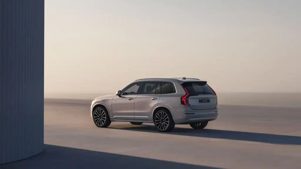 2026 Volvo XC90 luxury three-row SUV in silver viewed from rear three-quarter angle on open road near Johnson City TN