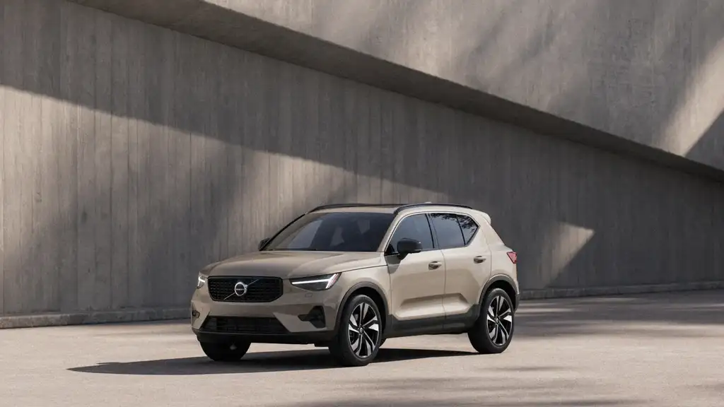 2026 Volvo XC40 in sand beige with black trim and alloy wheels parked against a concrete wall, available near Johnson City TN