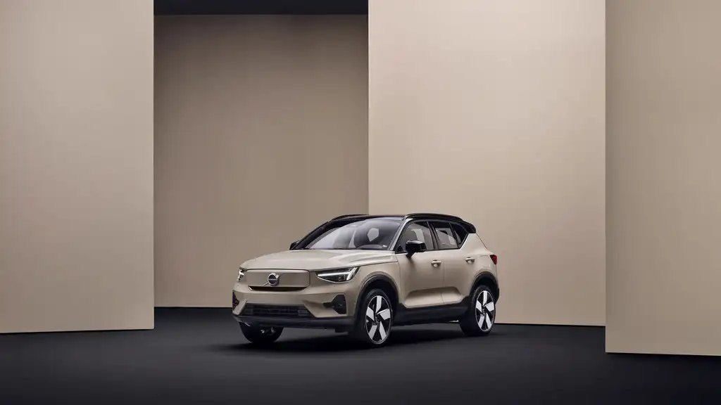2026 Volvo EX40 electric SUV in sandy beige with black roof and aerodynamic wheels displayed in modern studio setting near Asheville NC
