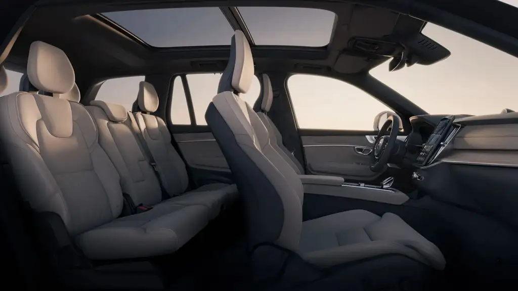 2026 Volvo XC90 plug-in hybrid interior showing spacious three-row seating in beige with panoramic sunroof near Asheville NC