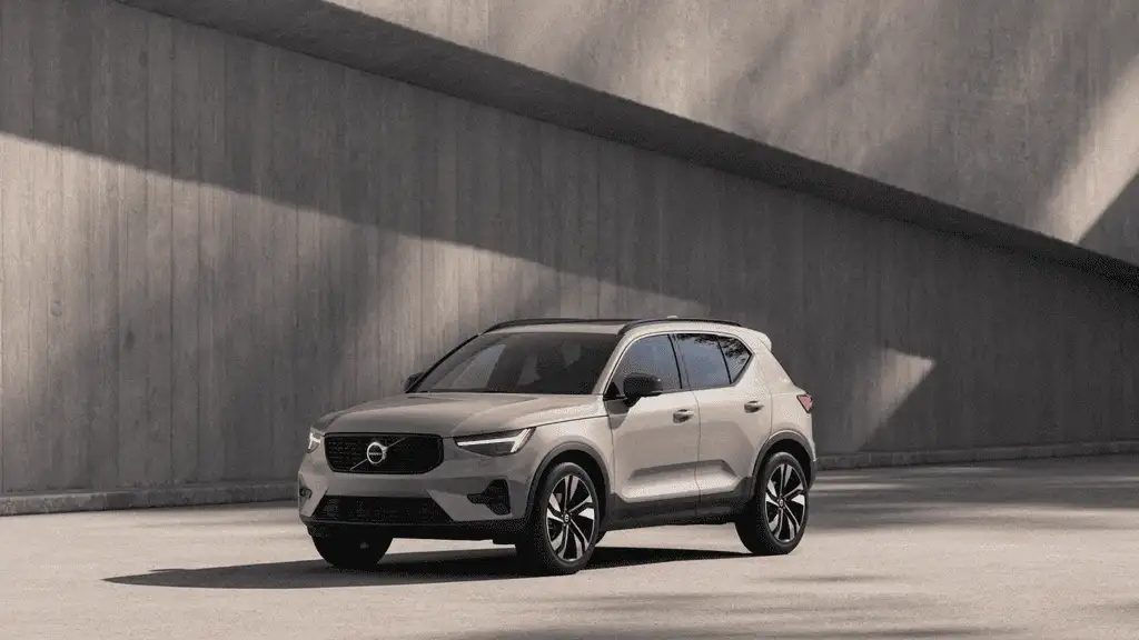 2026 Volvo XC40 tan beige SUV exterior parked against concrete wall nearby Kingsport TN