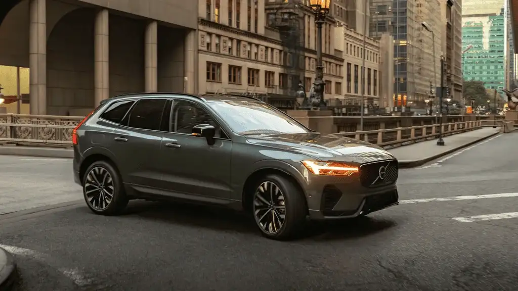 2026 Volvo XC60 plug-in hybrid gray SUV driving through city street nearby Kingsport TN