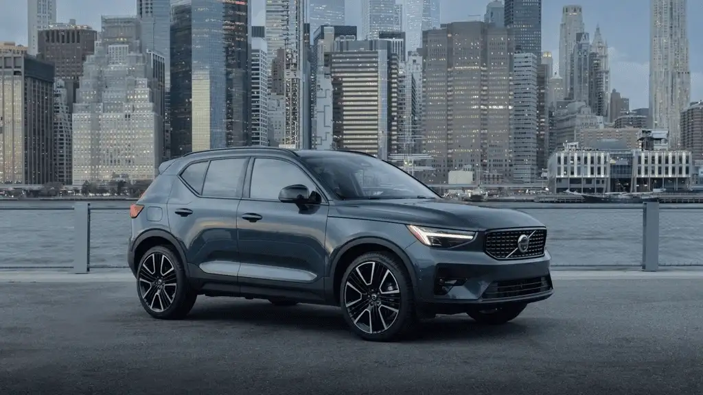 2026 Volvo XC40 compact SUV parked by a city waterfront with modern skyscrapers near Kingsport, TN