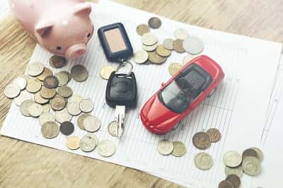 Toy car, coins, and keys representing Toyota financing