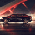A pre-owned Toyota sedan on the road at night