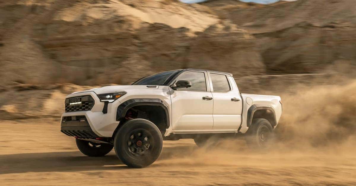 2026 Toyota Tacoma pickup truck driving through desert terrain