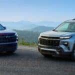 Red and Gray 2024 Chevy Traverse Models Overlooking Mountains