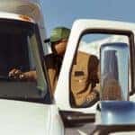 international LT foreground cab male-driver-boarding snowy mountains