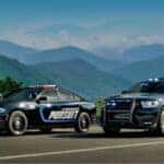 Dodge Durango and Charger Police Vehicles Driving on a Country Highway