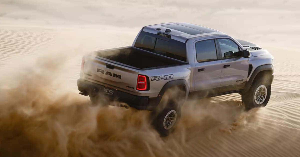 2025 Ram 1500 Rebel X driving over a sand dune