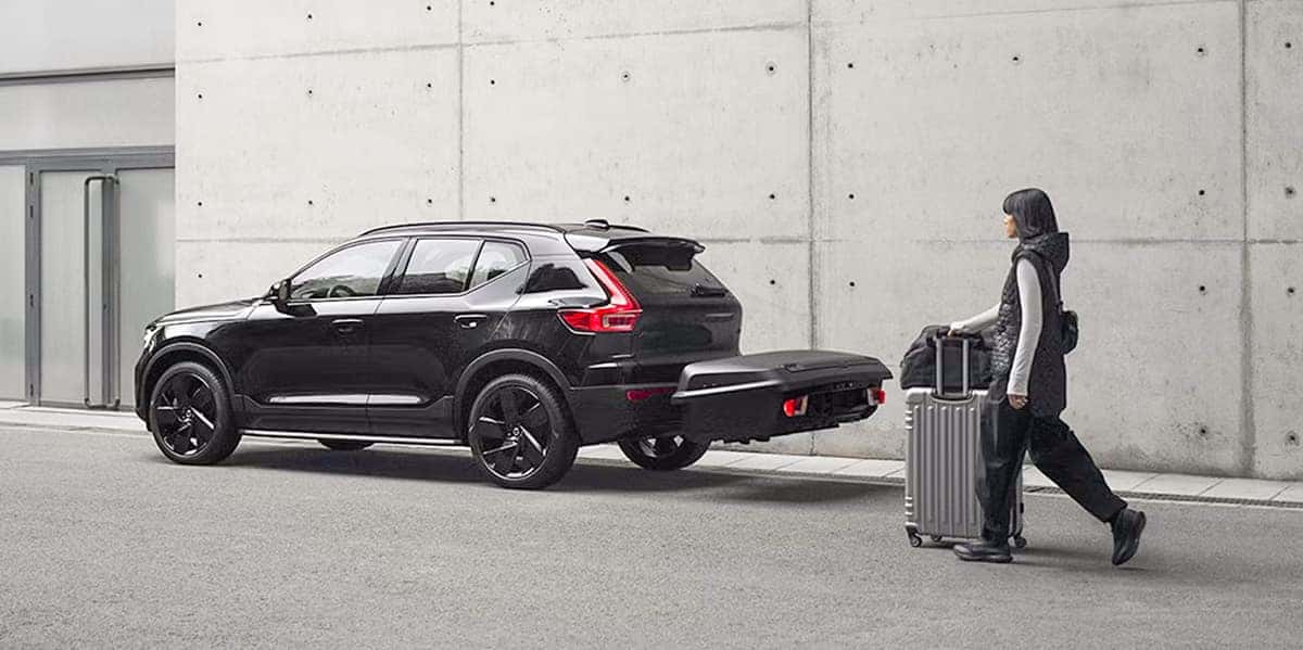 Person walking to a volvo veshicle with a hitch rack