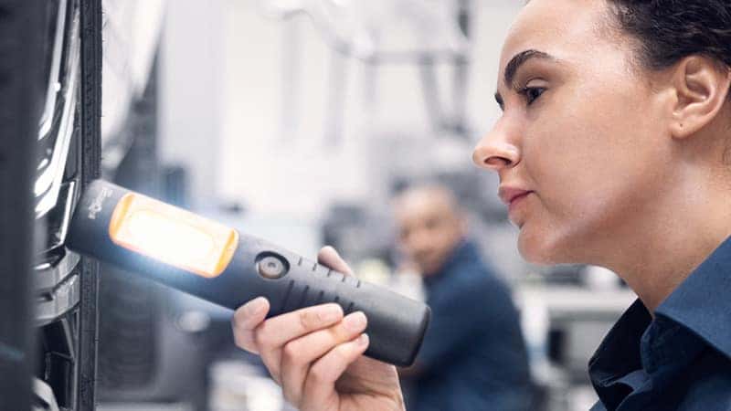 A Technician Performing Inspection on a Volvo Vehicle