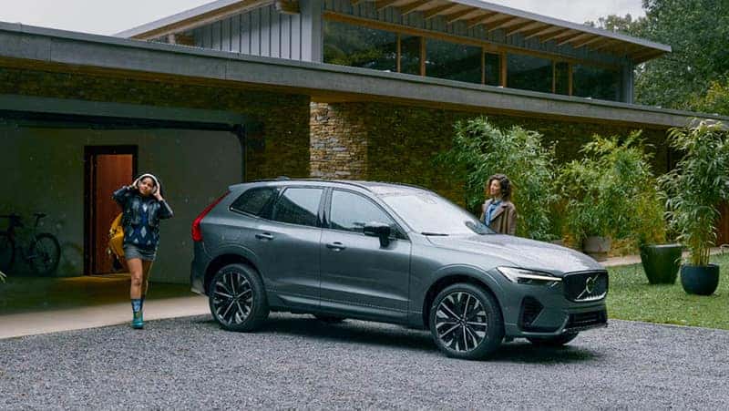 a parent and a walking to a Volvo vehicle