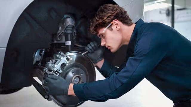 A Technician Performing Inspection on a Volvo Vehicle