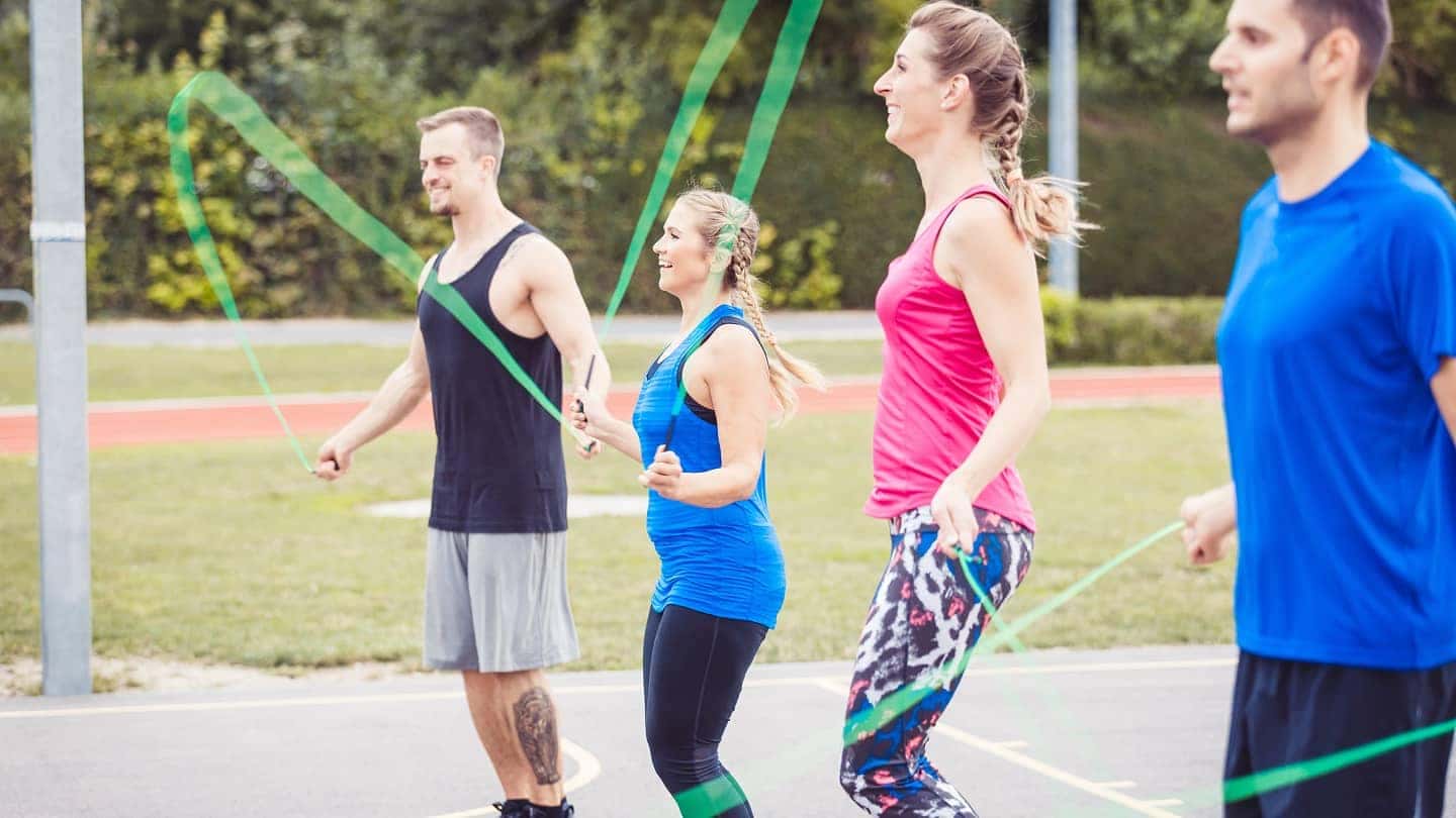 group of adults jump roping