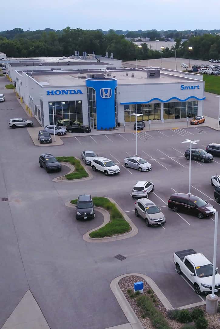 Exterior shot of a Honda vehicle parked on the side of a road.