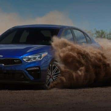 Kia_Forte_Blue_GT_Driving_On_Dirt
