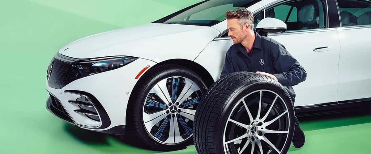 Technician changing tires on EQS vehicle