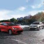 Kia Rio cars parked under blue sky