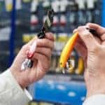 Fishing lure baits in the hands of man in the store