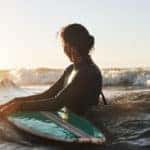 Shot of a young woman surfing in the ocean