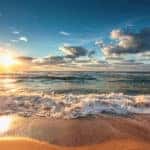 horizon shot of water crashing onto beach