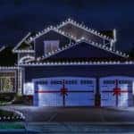 Night time photo of a modern American suburban home decorated with festive Christmas holiday lights