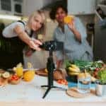 Mother and daughter streaming online virtual cooking lesson at home