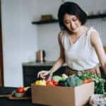 young woman received produce delivery