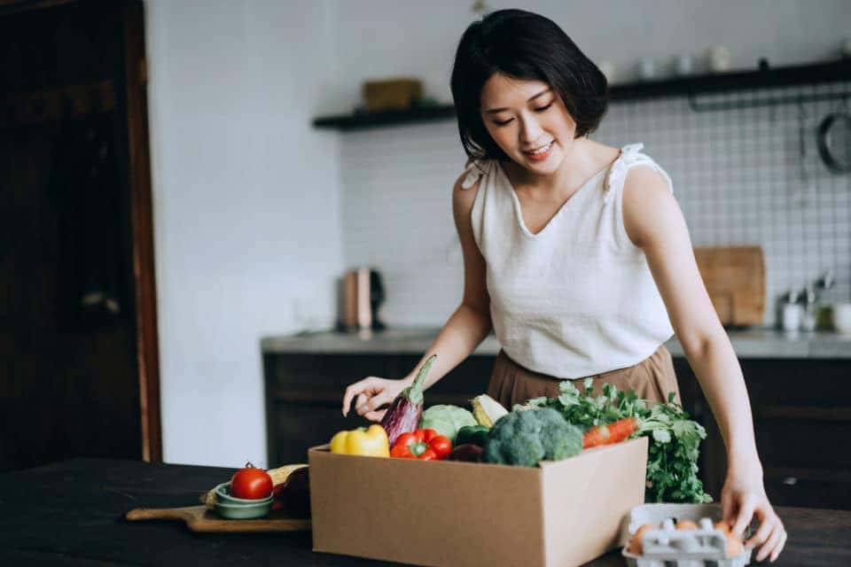 young woman received produce delivery