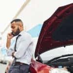 Shot of a man calling roadside assistance