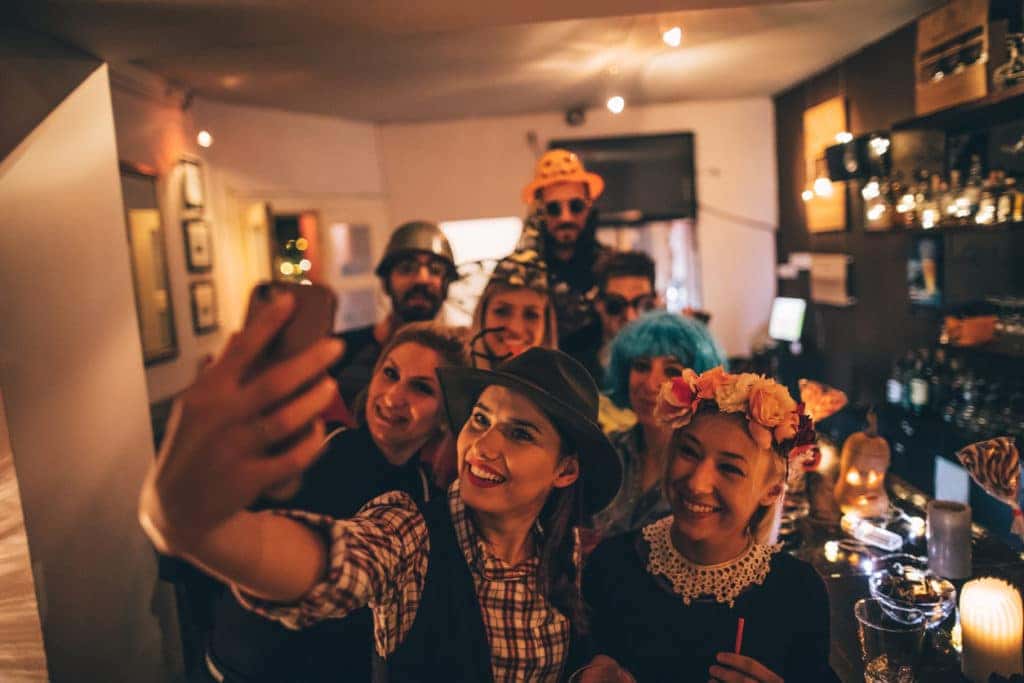 group of friends posing for a picture in costumes
